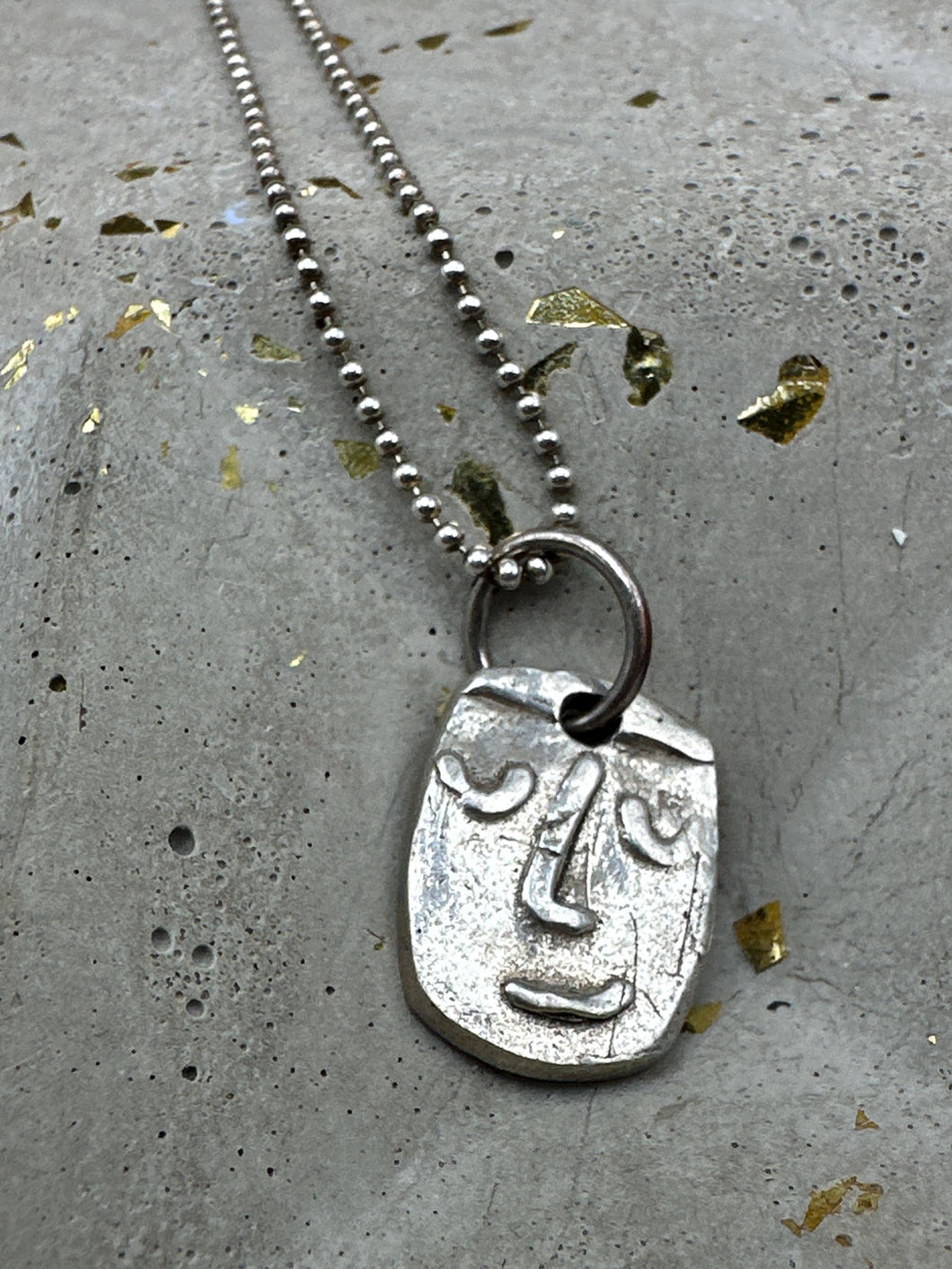 silver face necklace