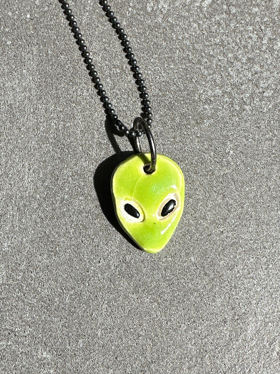 green alien necklace