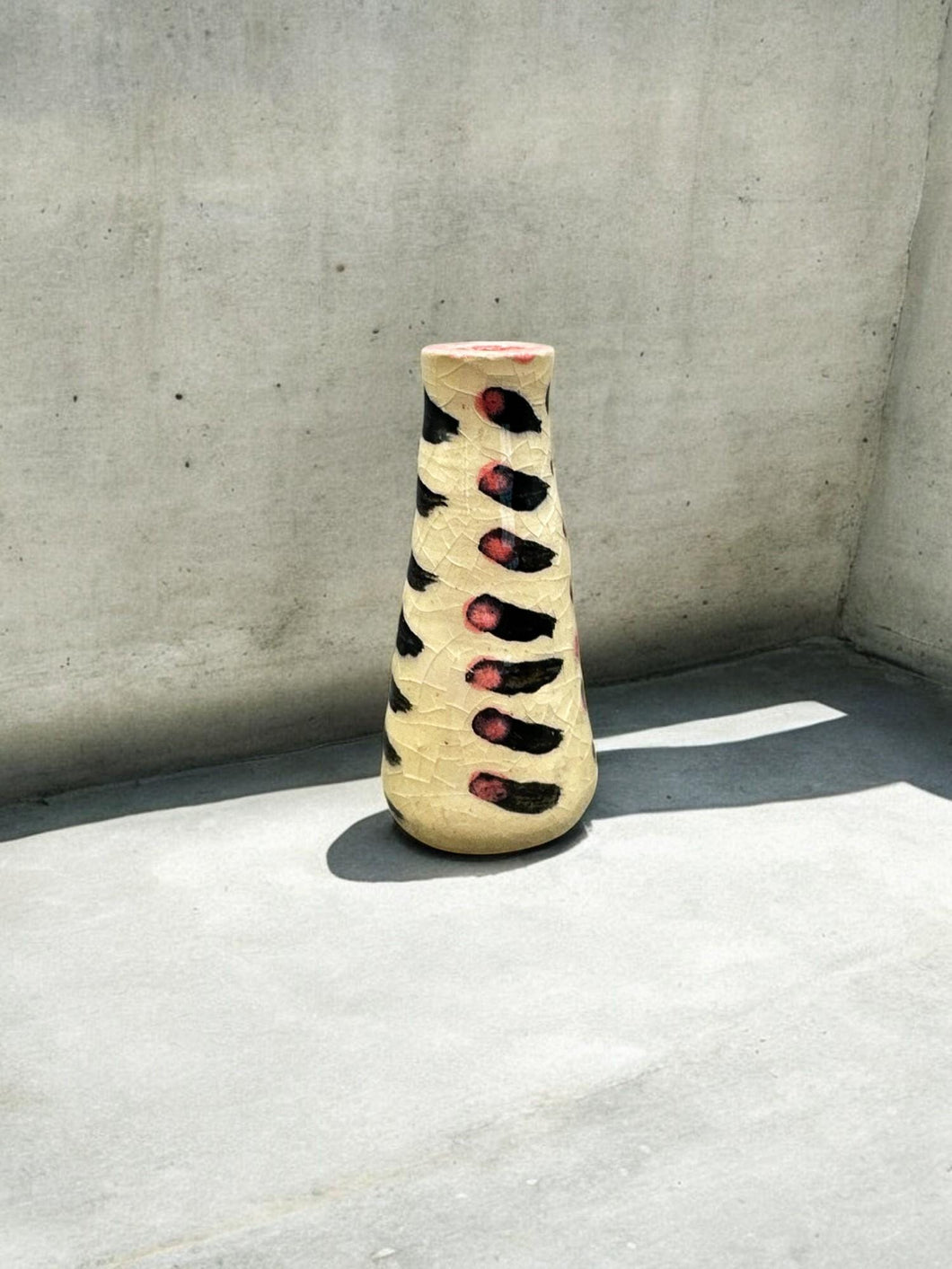 tiny pink and black vase