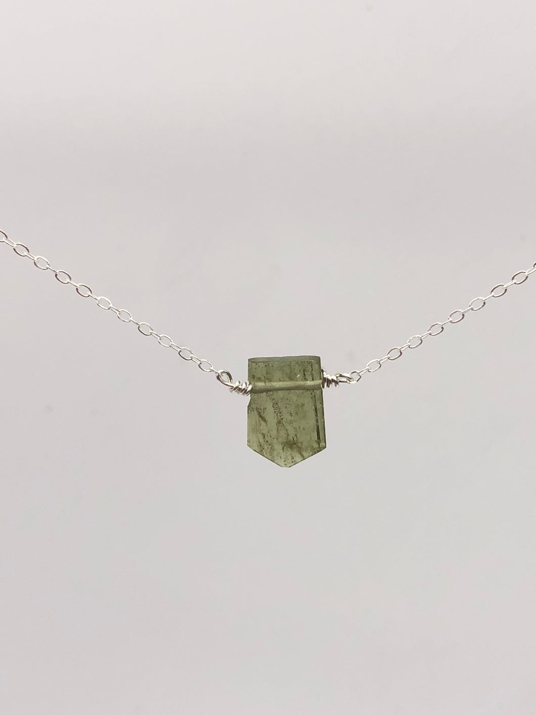 green tourmaline pendant on silver chain