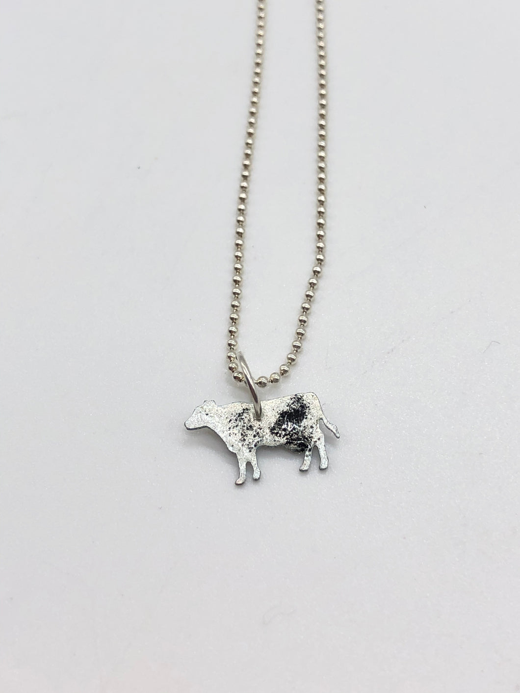 black and silver cow necklace