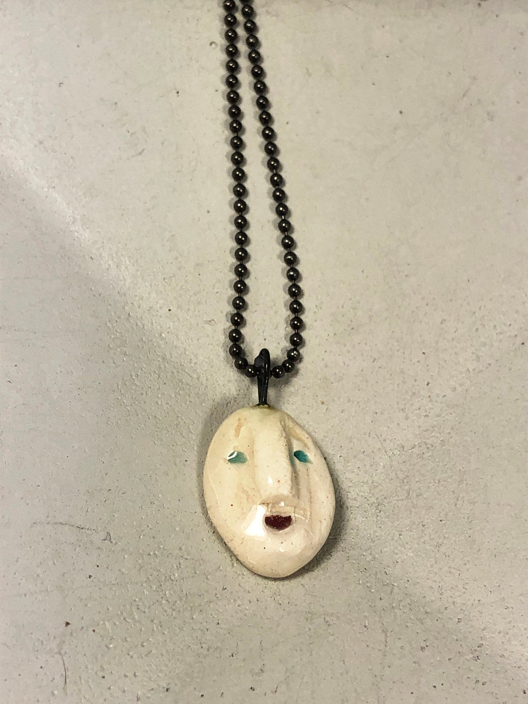 ceramic face pendant A