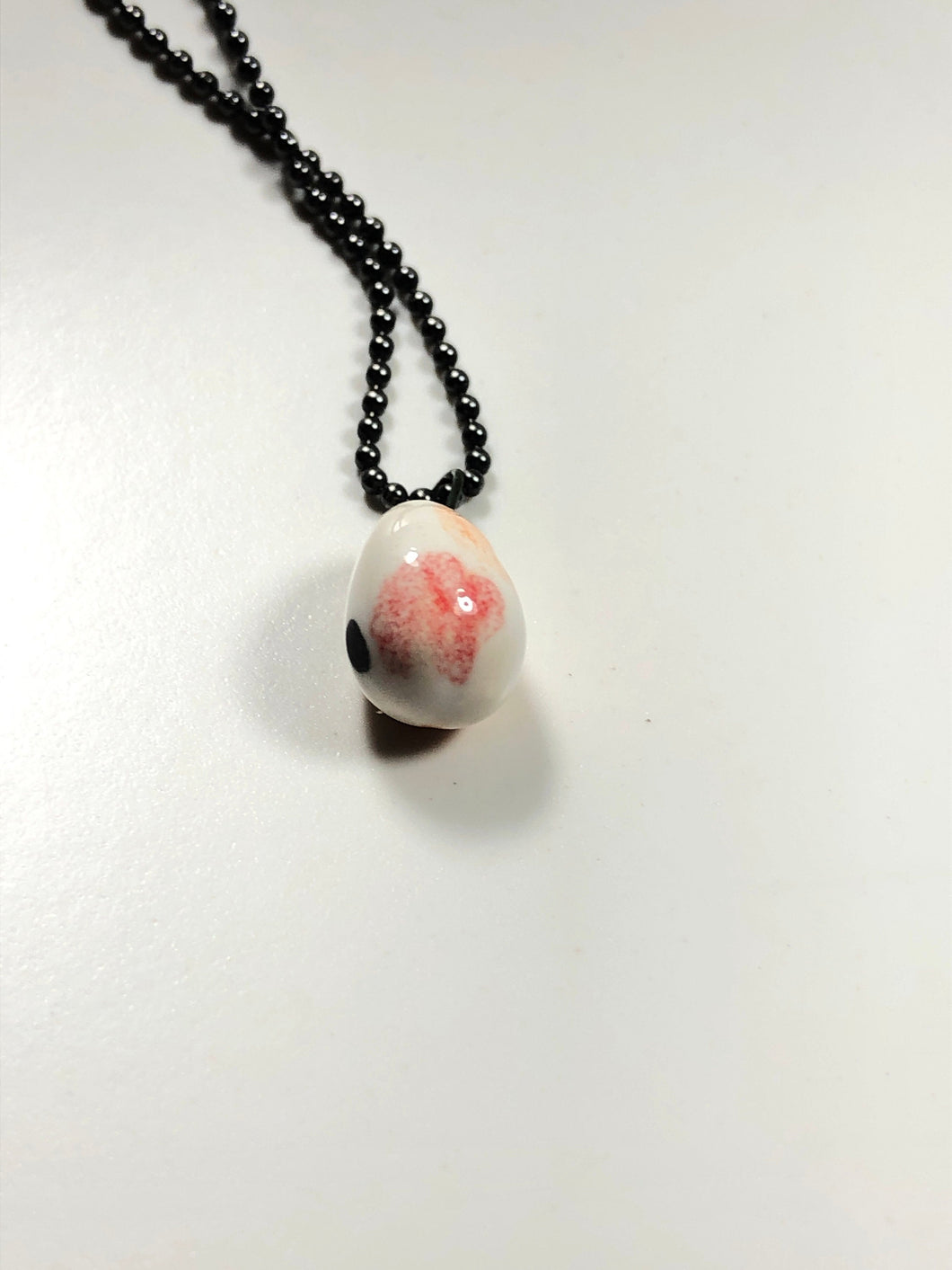 white, brown and red pendant