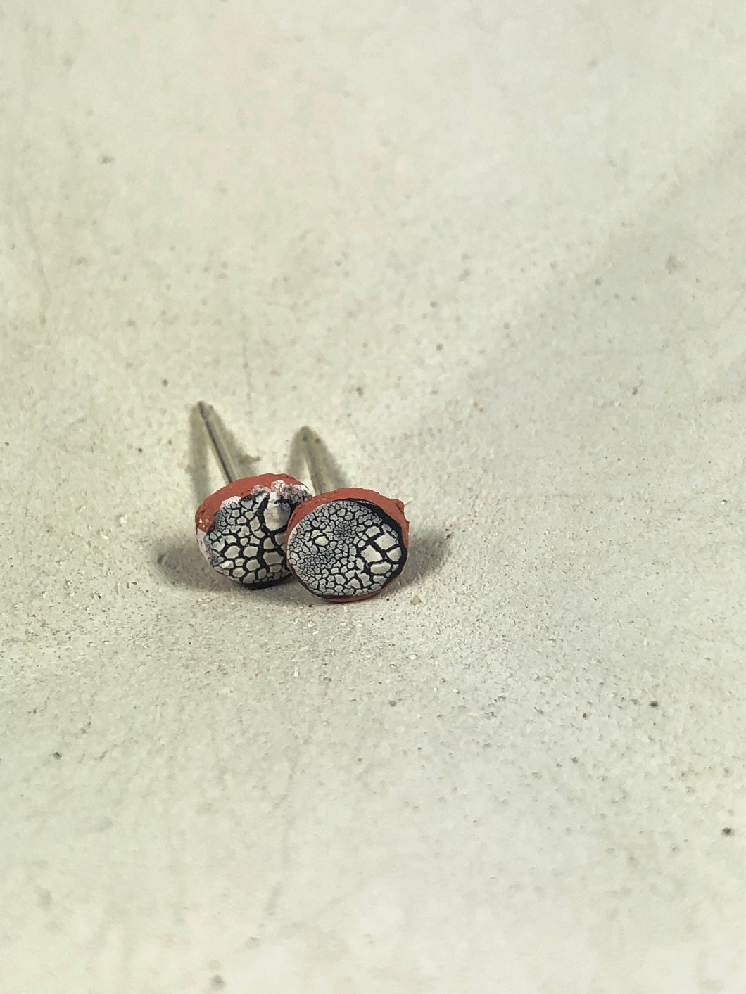 white and black on red clay crackle studs