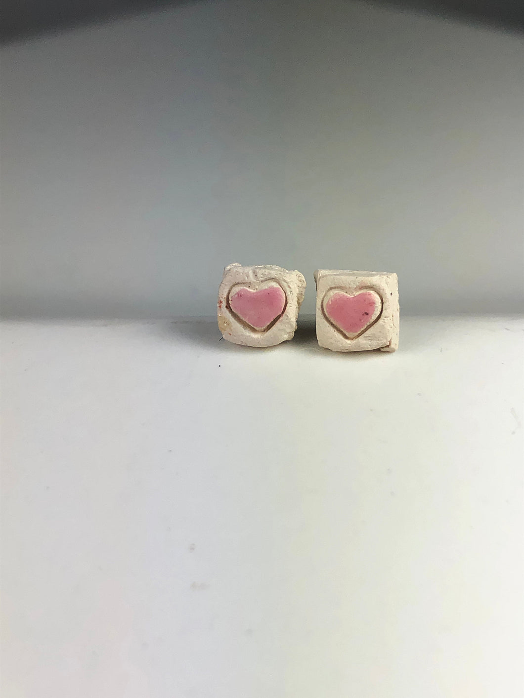 pink hearts on white ceramic studs